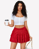 Red lace mini skirt with pleated waistband and layered ruffle hem