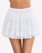 White lace mini skirt with tiered ruffles and pleated body