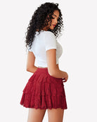 Red lace mini skirt with flared tiered ruffles and pleats at waist