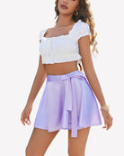 High-waist mini lingerie skirt in lavender with bow tie at waist and pleated flare