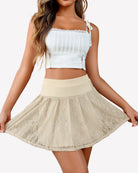 White pleated lace mini skirt with wide waistband and flared A-line silhouette
