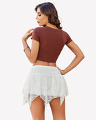 White layered asymmetrical short skirt with gathered ruffles and sheer lace uneven hem