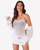 Floral sheer cami top with lace neckline, spaghetti straps, and drawstring waist tie