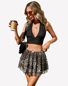 Leopard print pleated mini skirt with drawstring elastic waistband and flared tiered hem