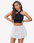 White pleated mini skirt with elastic waistband and tiered ruffle hem
