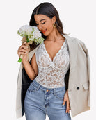 White lace V-neck bodysuit with floral lace texture and sheer neckline