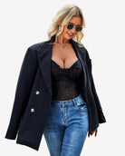 Black mesh cowl neck sequin tank top under a dark blazer, front view