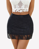 Black lace mini skirt with sheer mesh overlay and scalloped hem, fitted waistband.