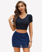 Navy lace mini skirt with sheer mesh overlay and scalloped hem, fitted high-waist.