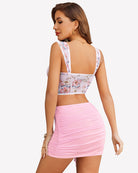Pink ruched mini skirt with gathered fabric and side tie at front