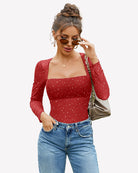 Red rhinestone mesh long-sleeve bodysuit with glitter dot pattern and square neckline