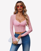 Light pink long-sleeve rhinestone crop top with sweetheart neckline