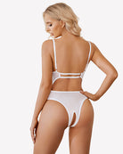 Cut-out crotchless babydoll teddy, white lace with open rear panels and strap details.