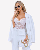 Cut-out crotchless babydoll teddy, white lace bodysuit with bra cups and lace paneling.