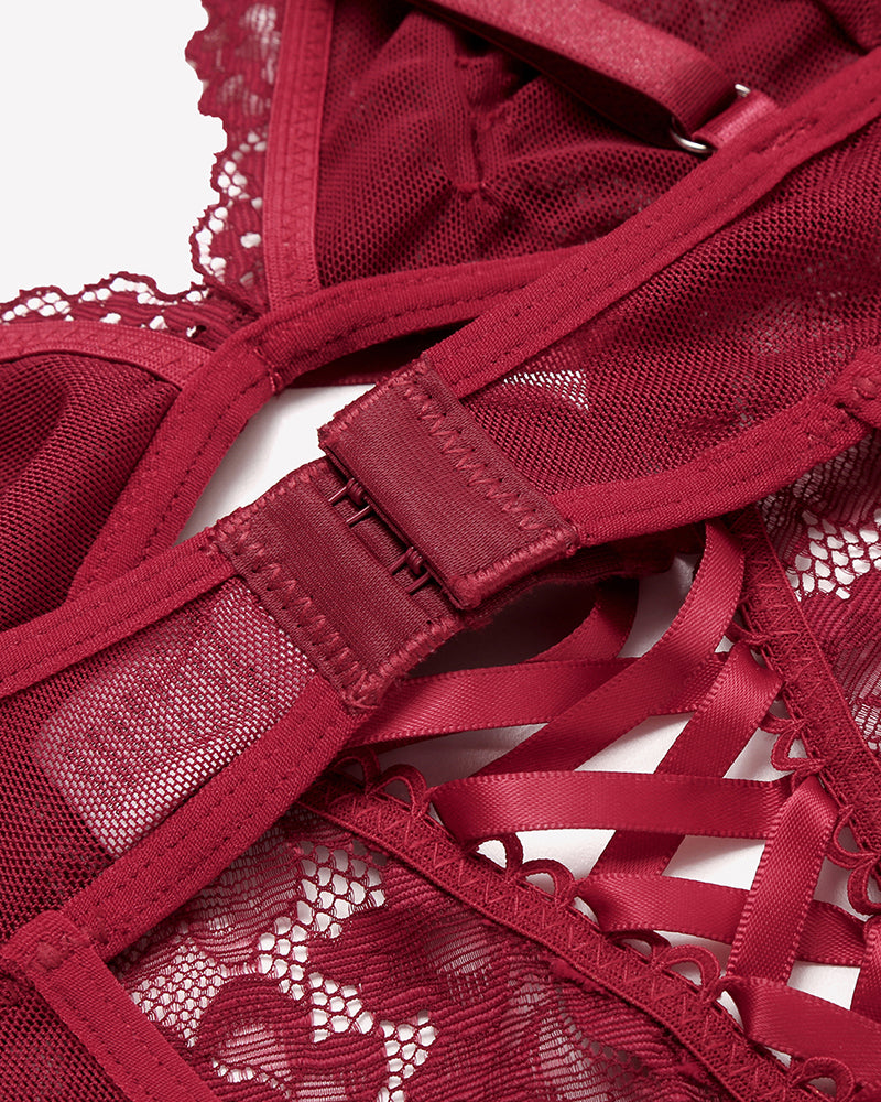 Wine red lace V-neck mini bodysuit close-up of crisscross lacing and adjustable strap tape