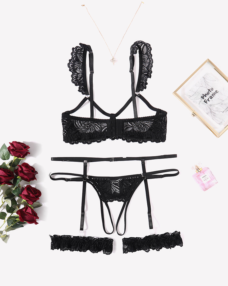 Black lace lingerie set: bra, garter straps and matching panty, flat lay