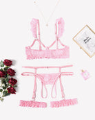 Pink lace lingerie set with bra, garter straps and matching panty, flat lay