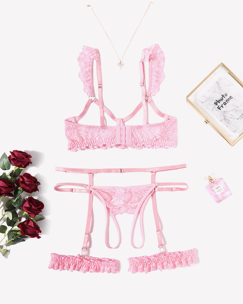 Pink lace lingerie set with bra, garter straps and matching panty, flat lay