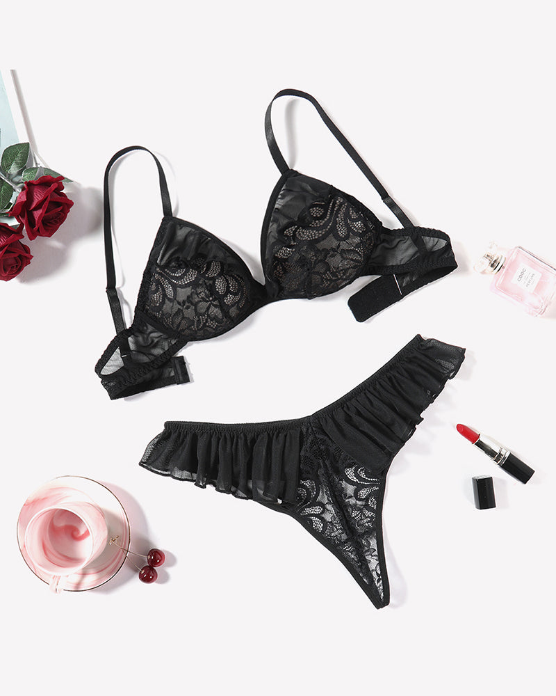 Black mesh lace bra and thong panty set with ruffle trim, laid out