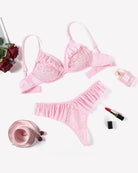 Pink lace bra and panty set with ruffled edges and scalloped lace trim