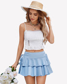 Light blue pleated mini skirt with layered ruffle tiers and side tie strings