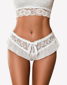 White floral lace briefs with scalloped leg trim and center bow