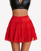 Red pleated mini skirt with tiered ruffles and drawstring front