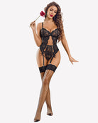 Black lace crotchless bodysuit with panty garter straps, holding accessory.