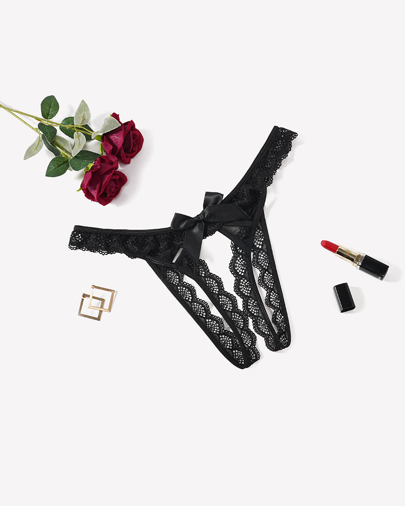 Black floral lace low-rise thong with a satin bow at the center front.