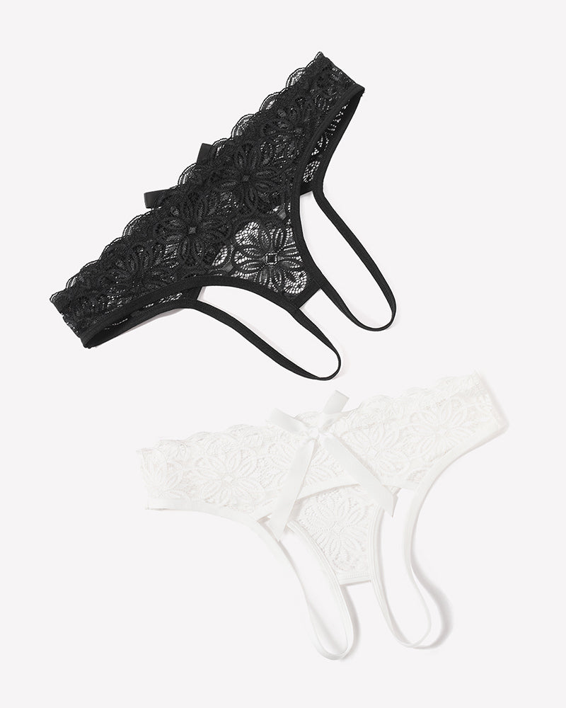 Black lace thong briefs and white lace thong briefs with bowknot accents, laid flat