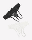 Black lace thong briefs and white lace thong briefs with bowknot accents, laid flat