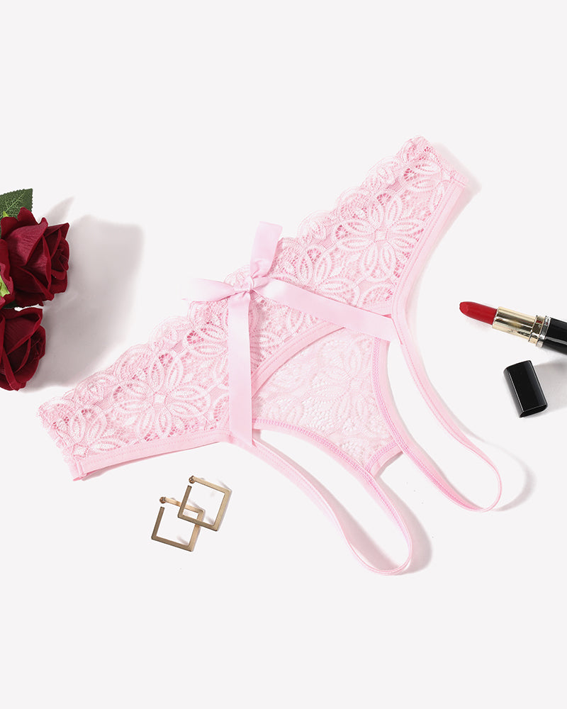 Pink lace briefs with openwork rear and back bow, scalloped edges, ribbon ties.