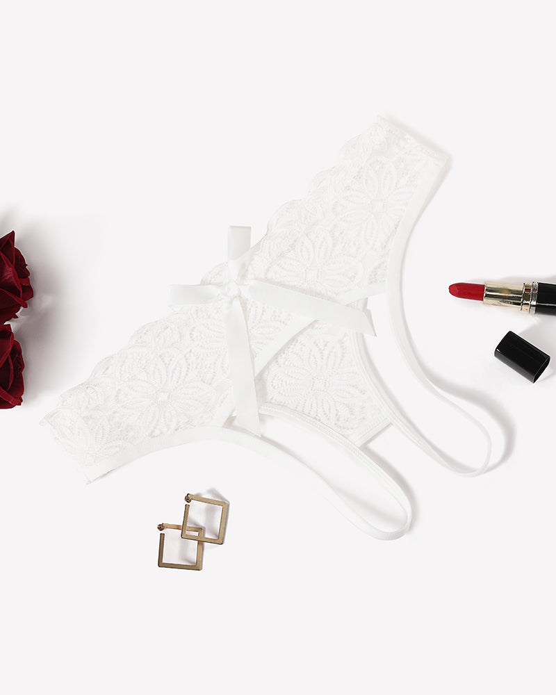 White lace briefs with openwork rear and back bow, scalloped edges, ribbon ties.