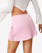 Pink satin A-line mini skirt with ruched side ties and elastic waist