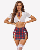 White sheer tie-front crop top with puff sleeves and red plaid mini skirt with lace thigh bands.