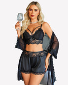 Black lace bra with satin shorts and sheer mesh robe, front view