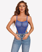 Fishnet bodysuit teddy in blue with thin straps and diamond mesh, worn with denim jeans.