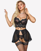 Black lace garter bralette with open-front mini skirt, G-string, and fishnet stockings