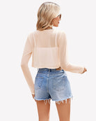Sheer cropped cardigan, long sleeves, open front in light champagne color.
