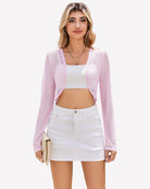 Sheer cropped cardigan, long sleeves, open front in pastel light purple.