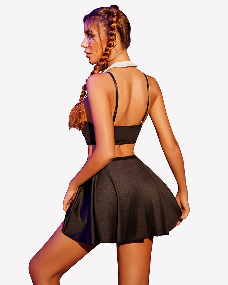 Black lingerie set with back view halter straps, red bow detail, and pleated mini skirt