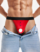 Red Santa g-string thong on model with black waistband and white pom-pom