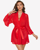 Red sheer robe with tied waist over lace bra and thong, front view.