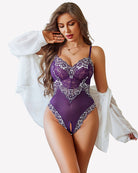 Purple lace crotchless bodysuit with V-neck, floral trim, and sheer mesh