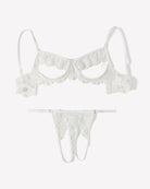 White floral lace cutout bra and matching thong set, flat lay with scalloped edges.
