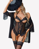 Black mesh lace cut-out teddy with scalloped lace edges and garter straps