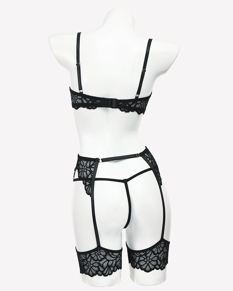 Black lace lingerie set on mannequin with strappy garter belt and high-cut panties