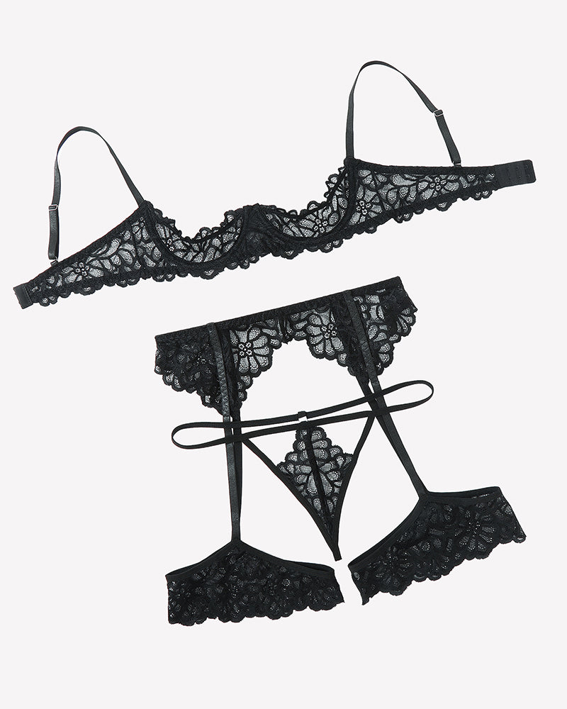 Black lace lingerie set flat lay: bralette, garter belt, and matching garter thong