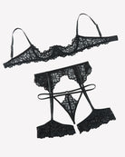 Black lace lingerie set flat lay: bralette, garter belt, and matching garter thong
