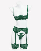Green lace lingerie set with garter belt and matching briefs, shown on mannequin